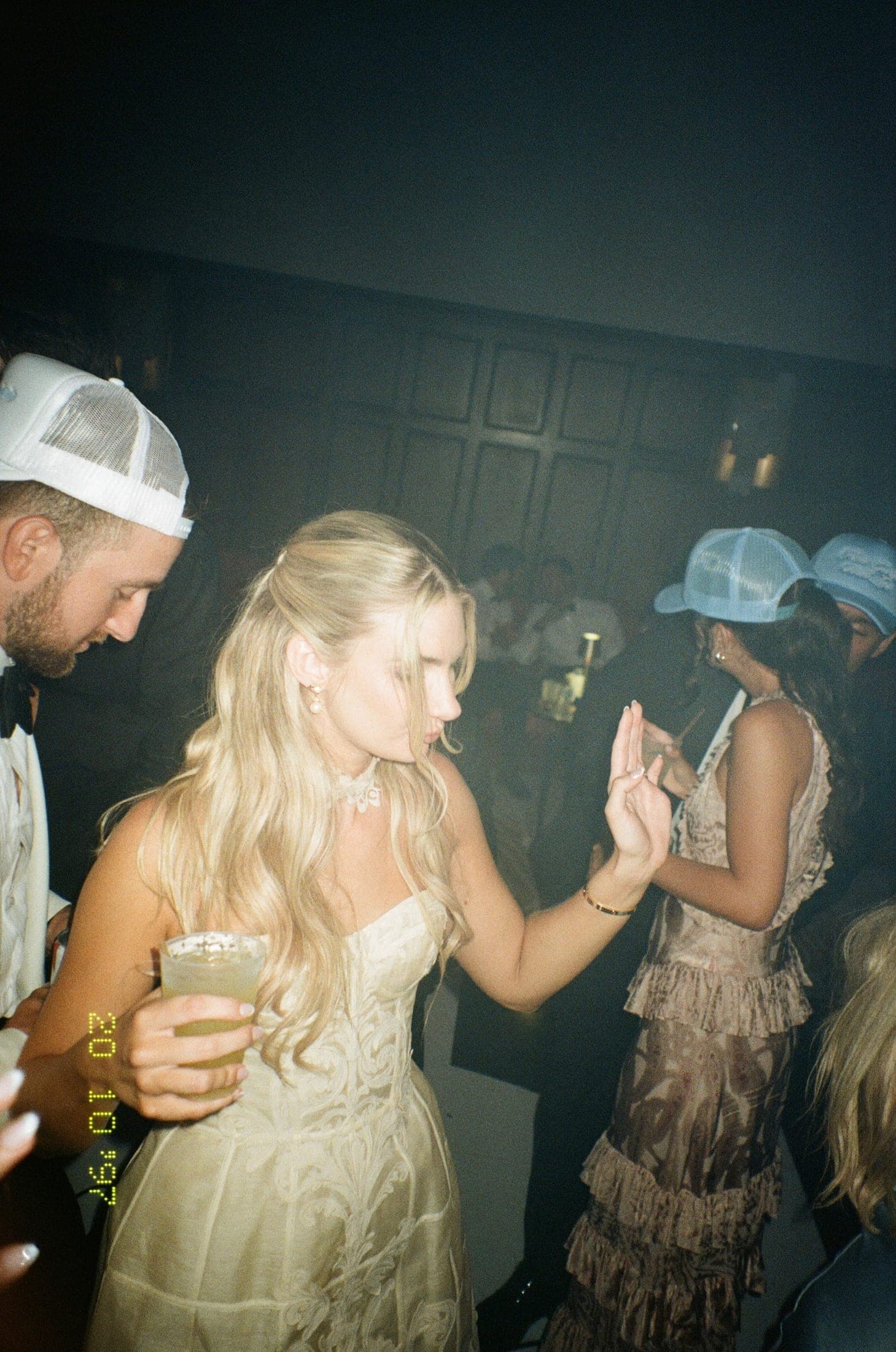 the bride dancing at the after-party, drink in hand