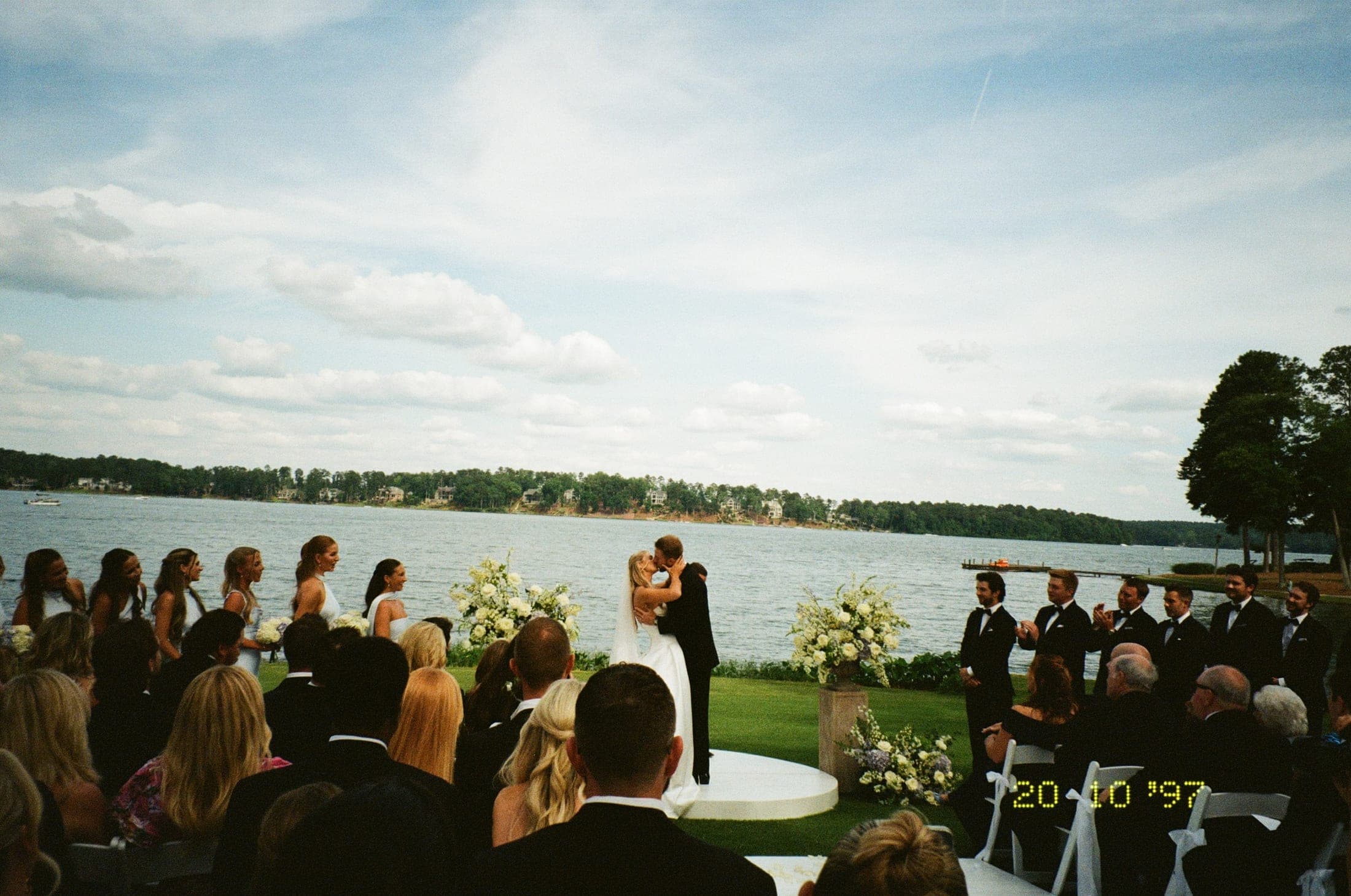 the first kiss seen from across the lawn, everyone watching
