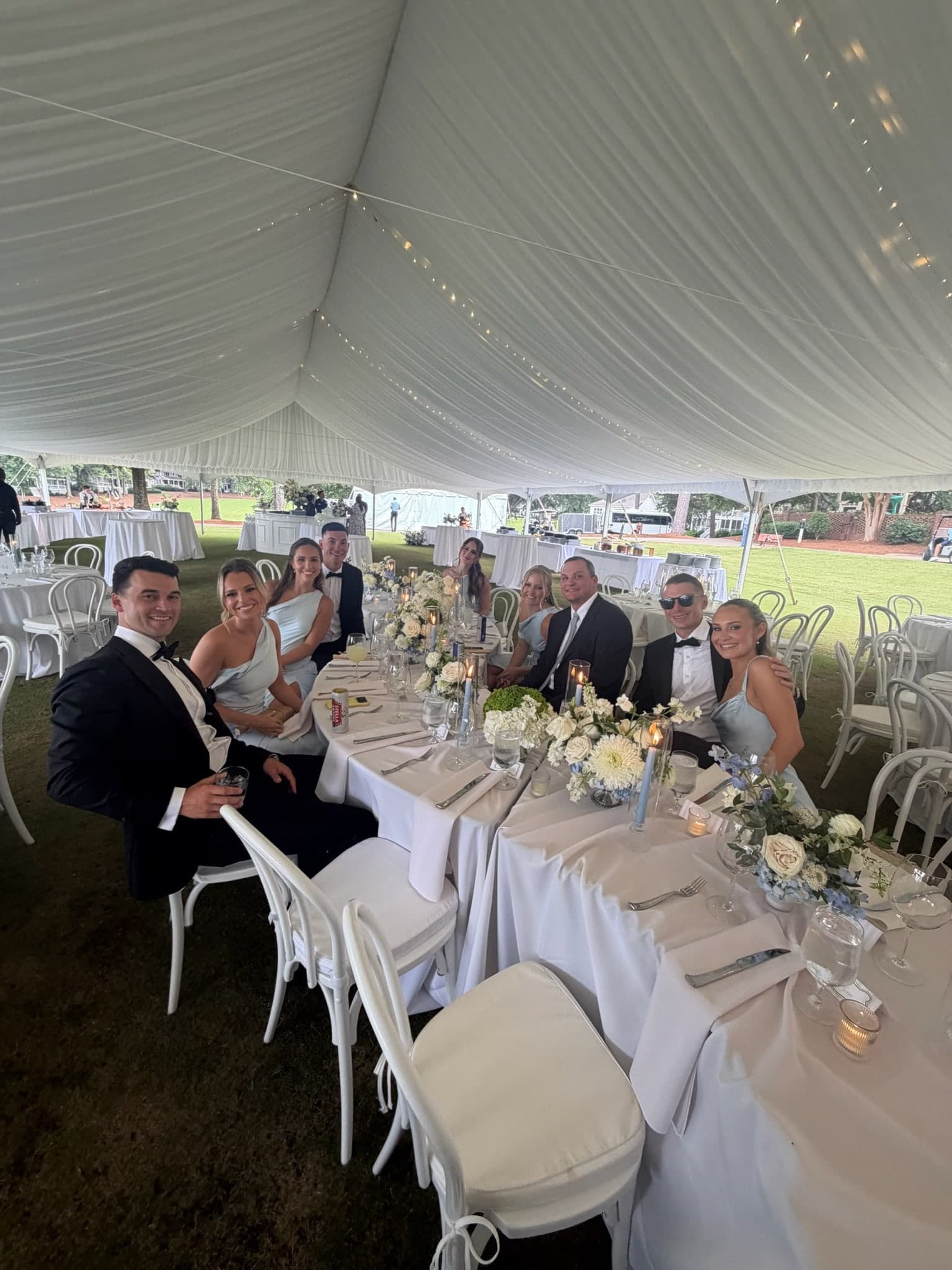 guests at the candlelit tables under the tent